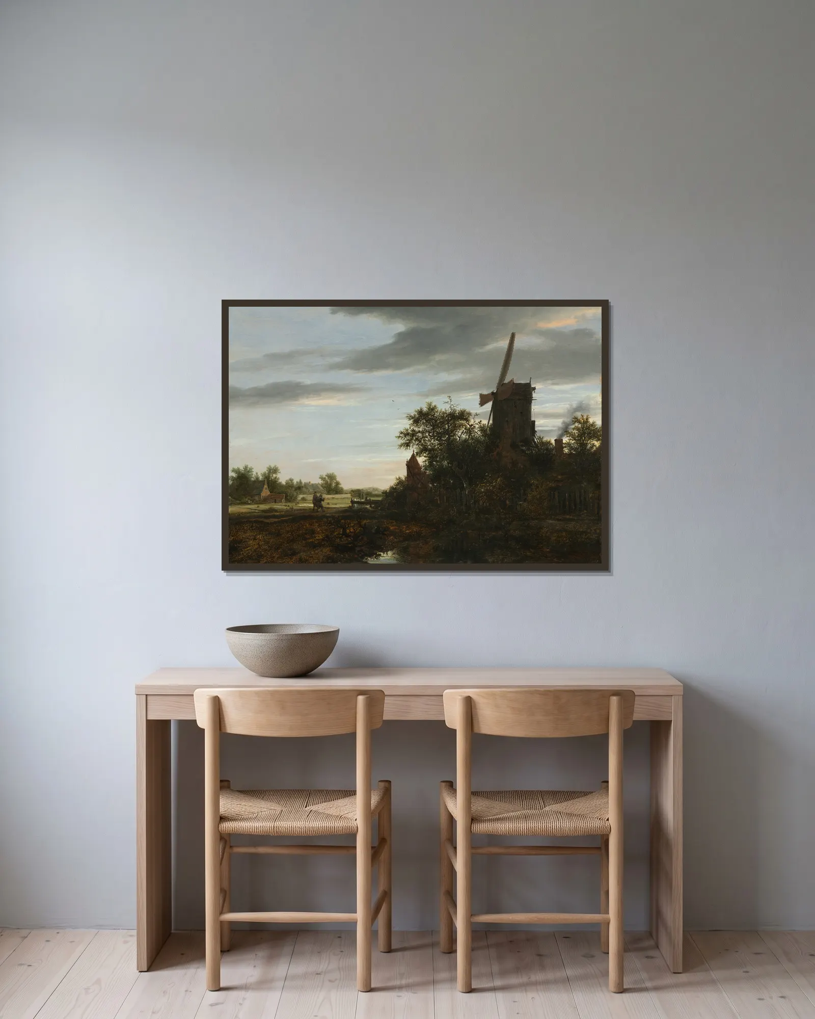 Landscape with a Windmill av Jacob van Ruisdael inramad på en vägg