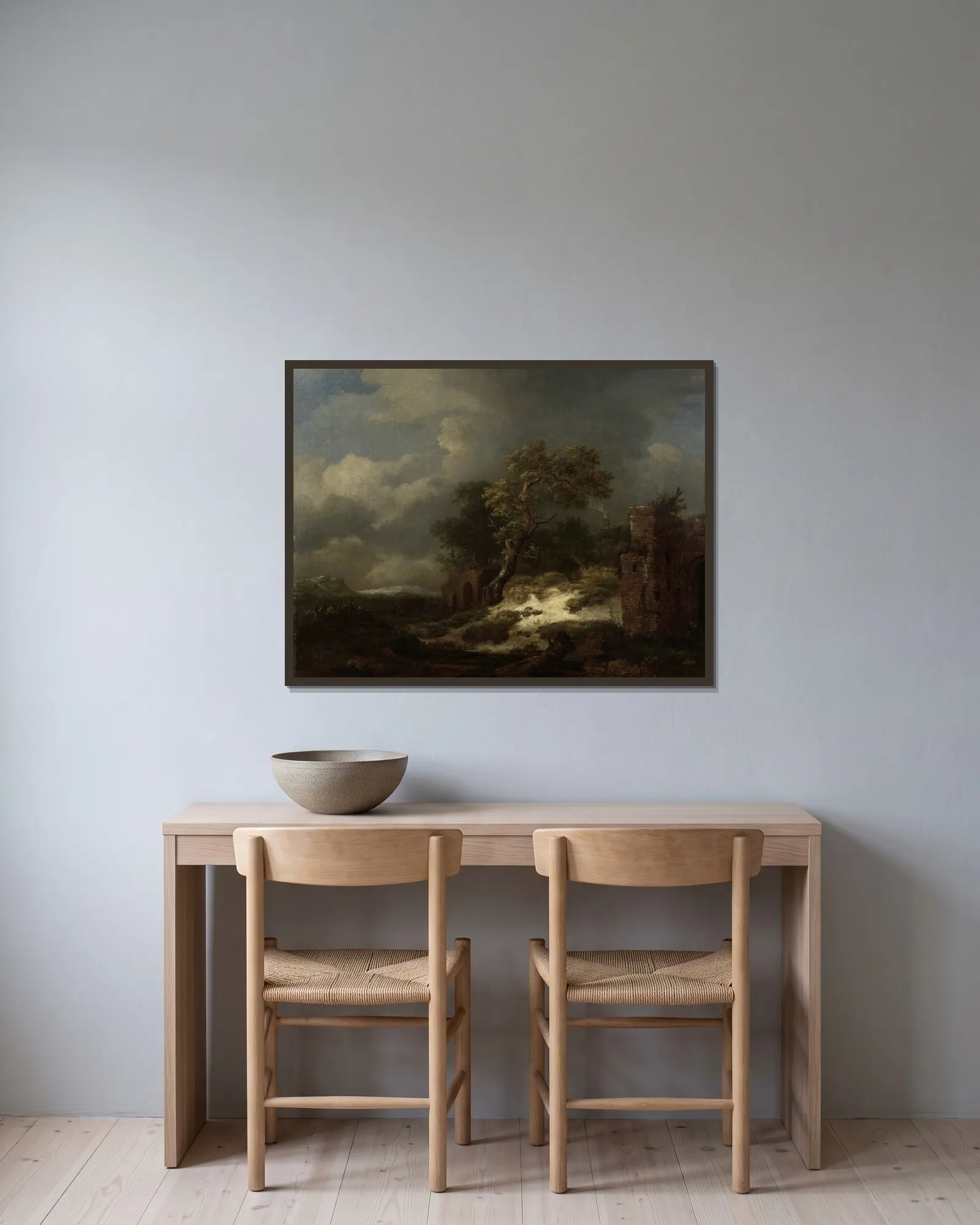Landscape with Ruins av Jacob van Ruisdael inramad på en vägg