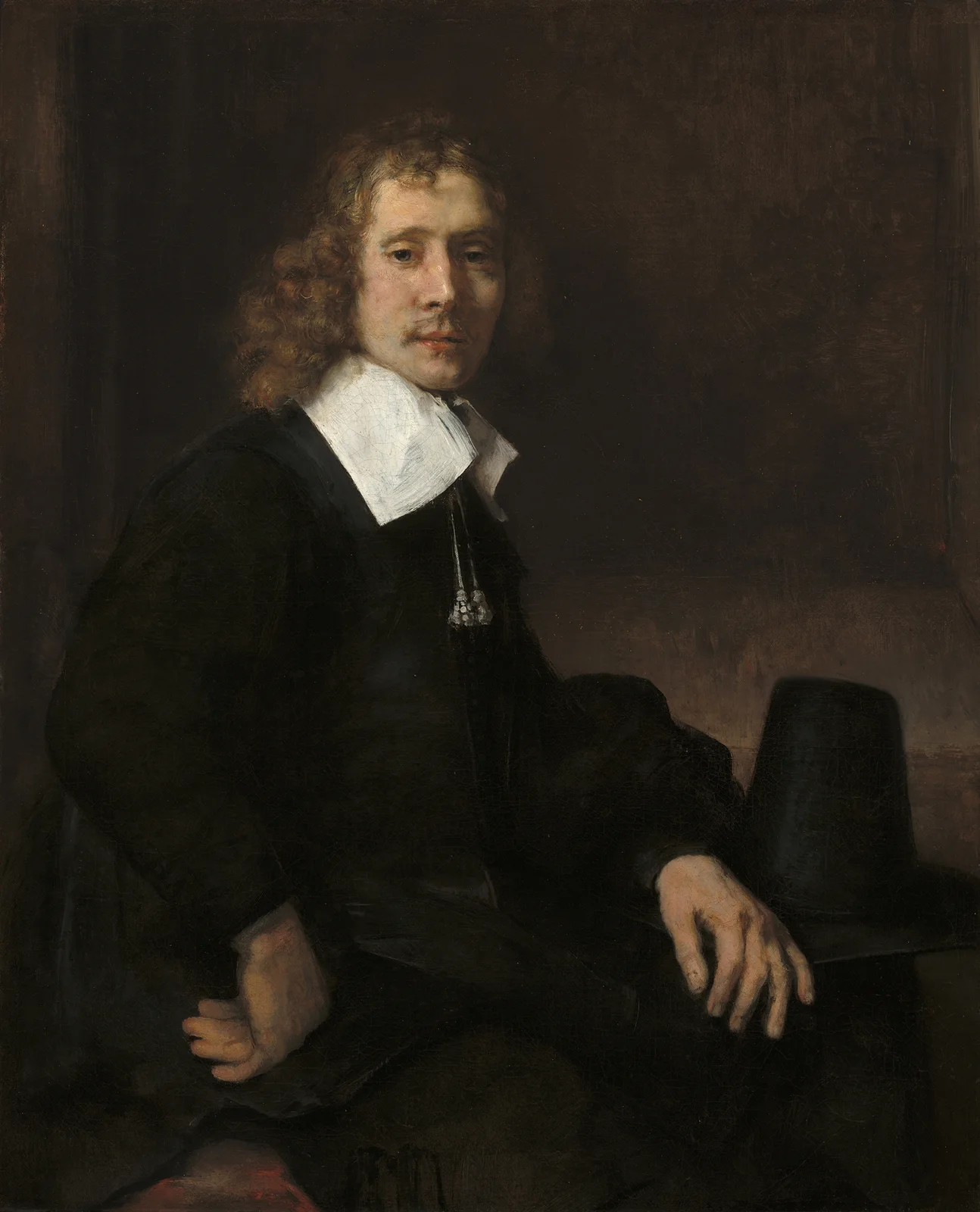 A Young Man Seated at a Table (possibly Govaert Flinck) av Rembrandt van Rijn