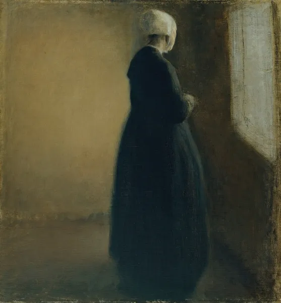 An old woman standing by a window av Vilhelm Hammershøi